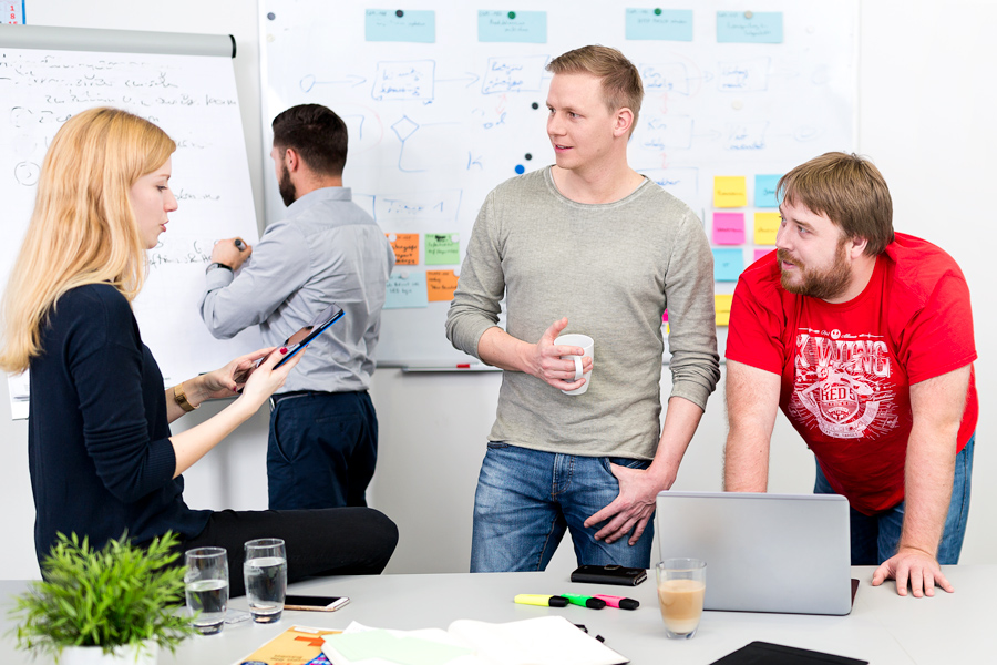 Product Manager David Moog and colleagues looking at the task board