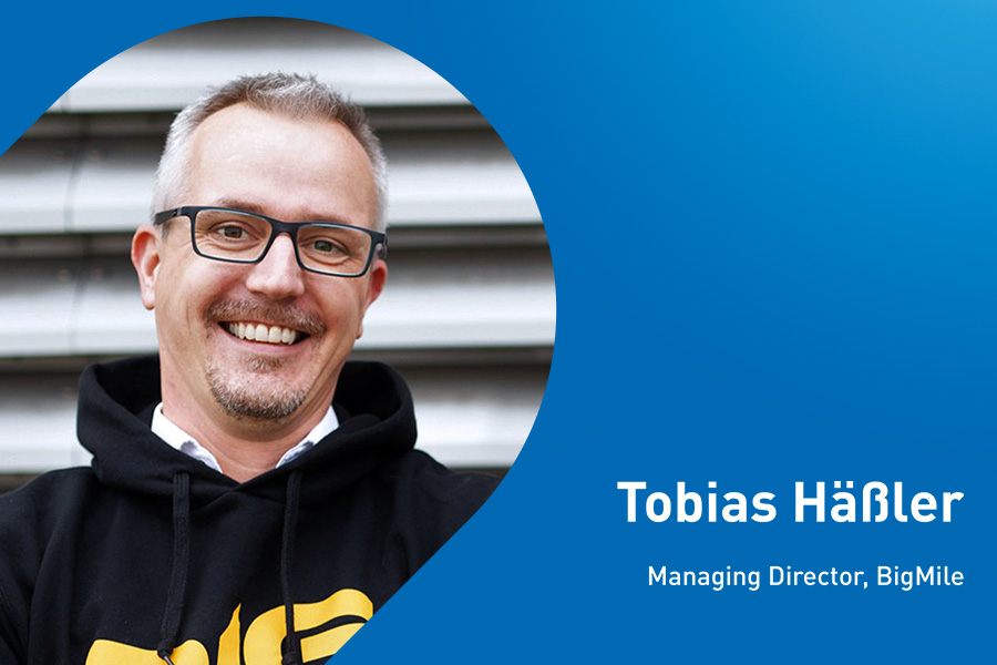 The image shows Tobias Häßler, Managing Director at BigMile, a TIMOCOM partner.