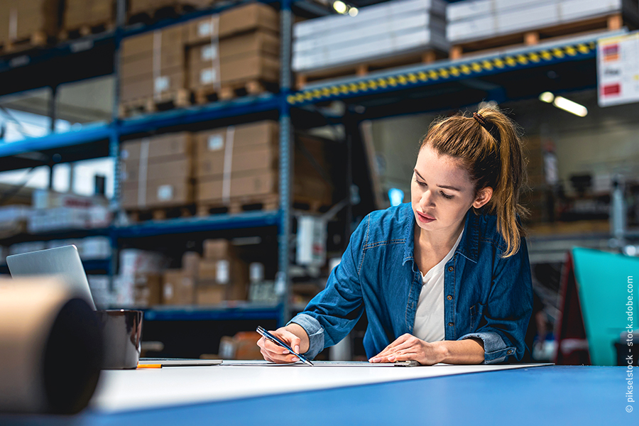 woman working at table in warehouse