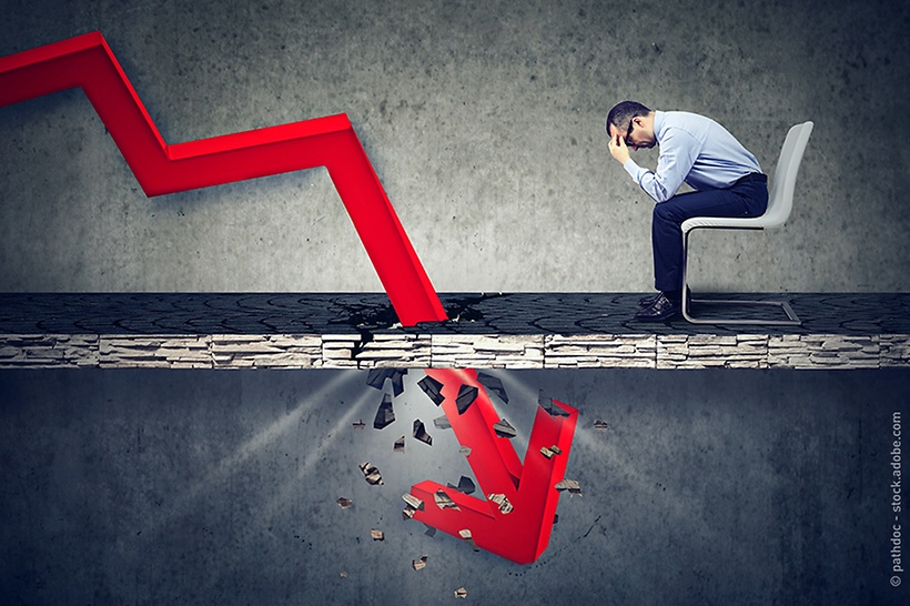 a man sits beside the graph