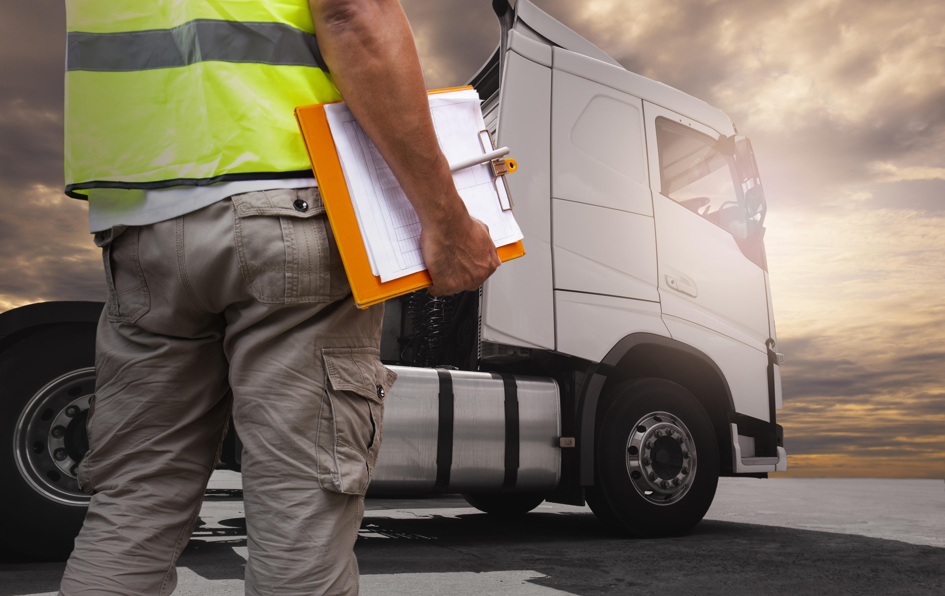 Documents and pen in front of white truck