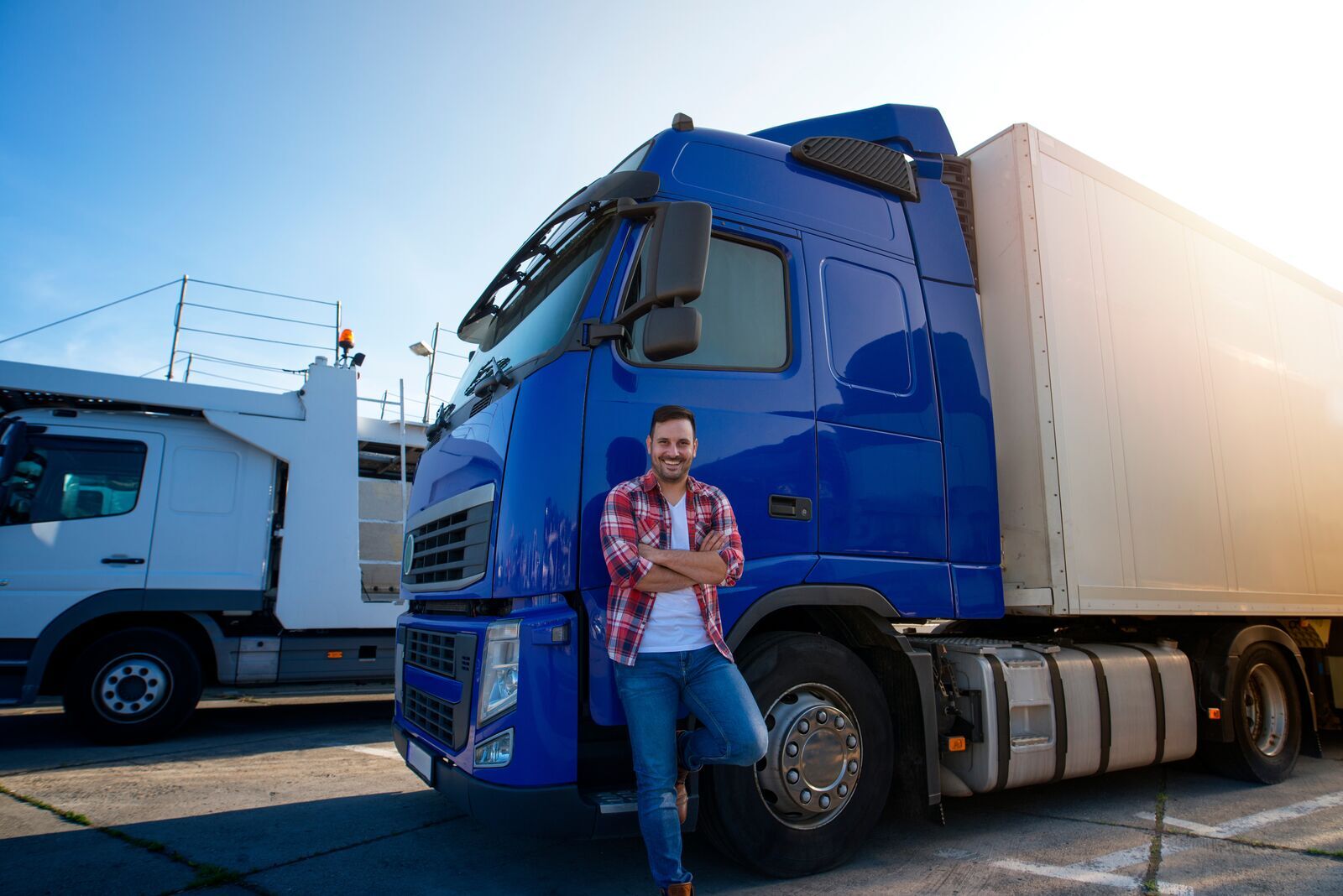 Truck driver in front of blue truck